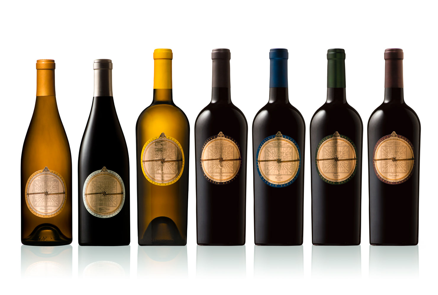 Seven Captain’s Reserve wine bottles with circular astrolabe labels and colour-coded rims