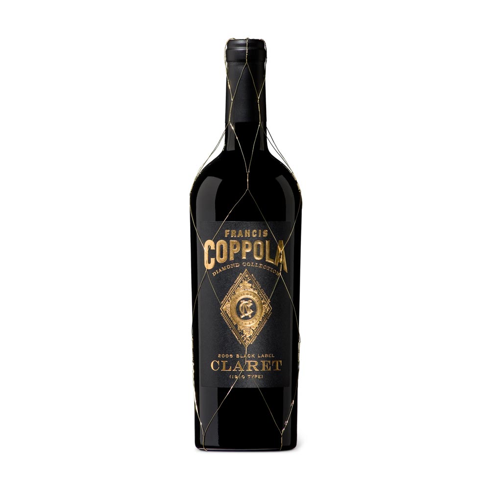Francis Coppola Claret bottle with a matte black and gold label and gold wire net
