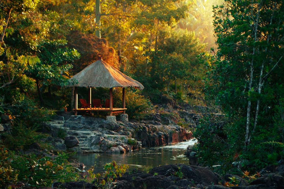Riverside pavilion at Blancaneaux Lodge in warm morning light