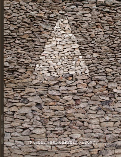 Resort brochure cover with a triangular mark in a stone wall
