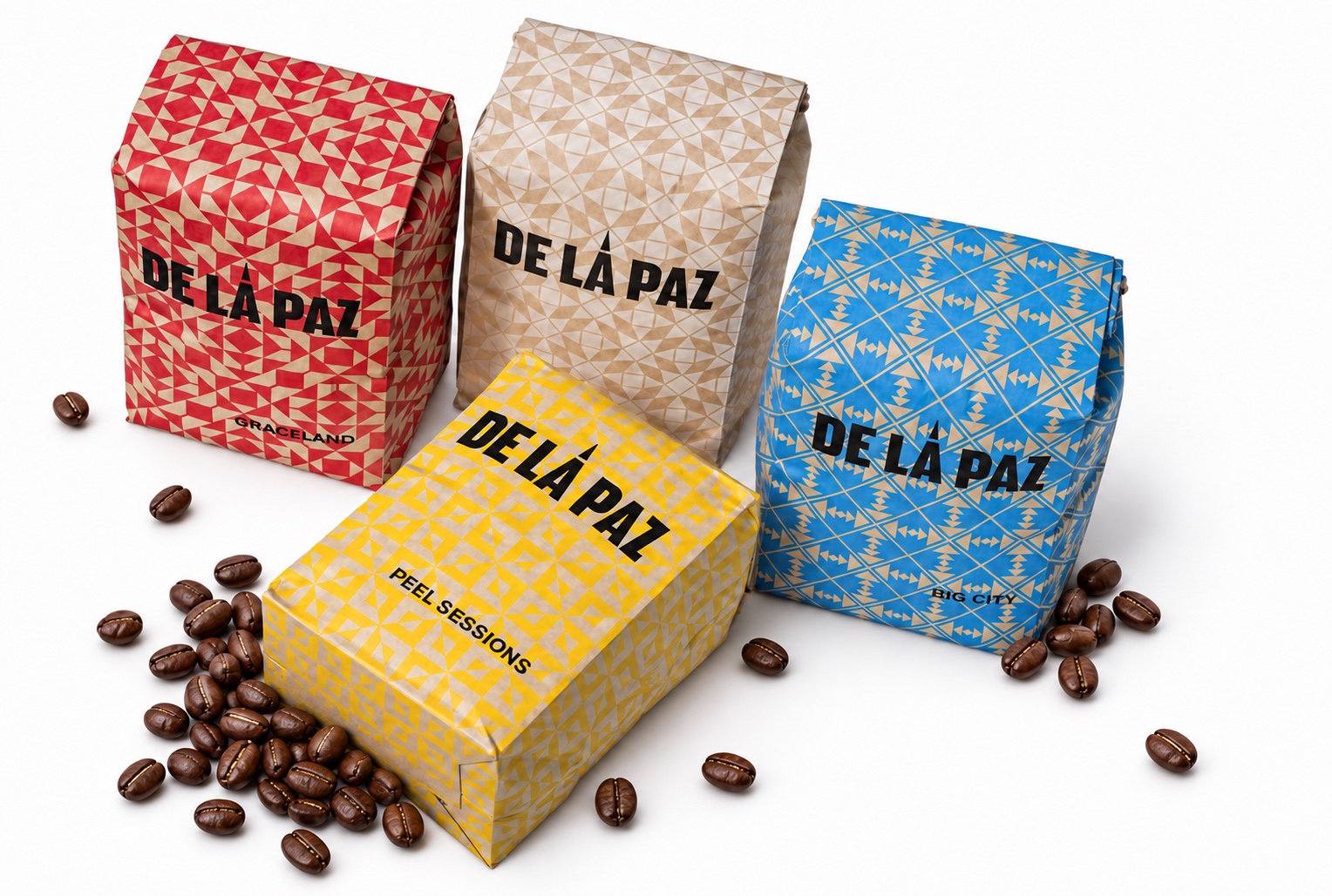De La Paz coffee bags with colourful patterns and scattered coffee beans