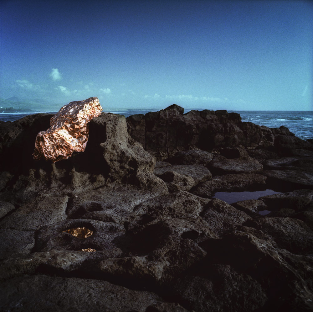 Copper on coastal rocks beside the sea