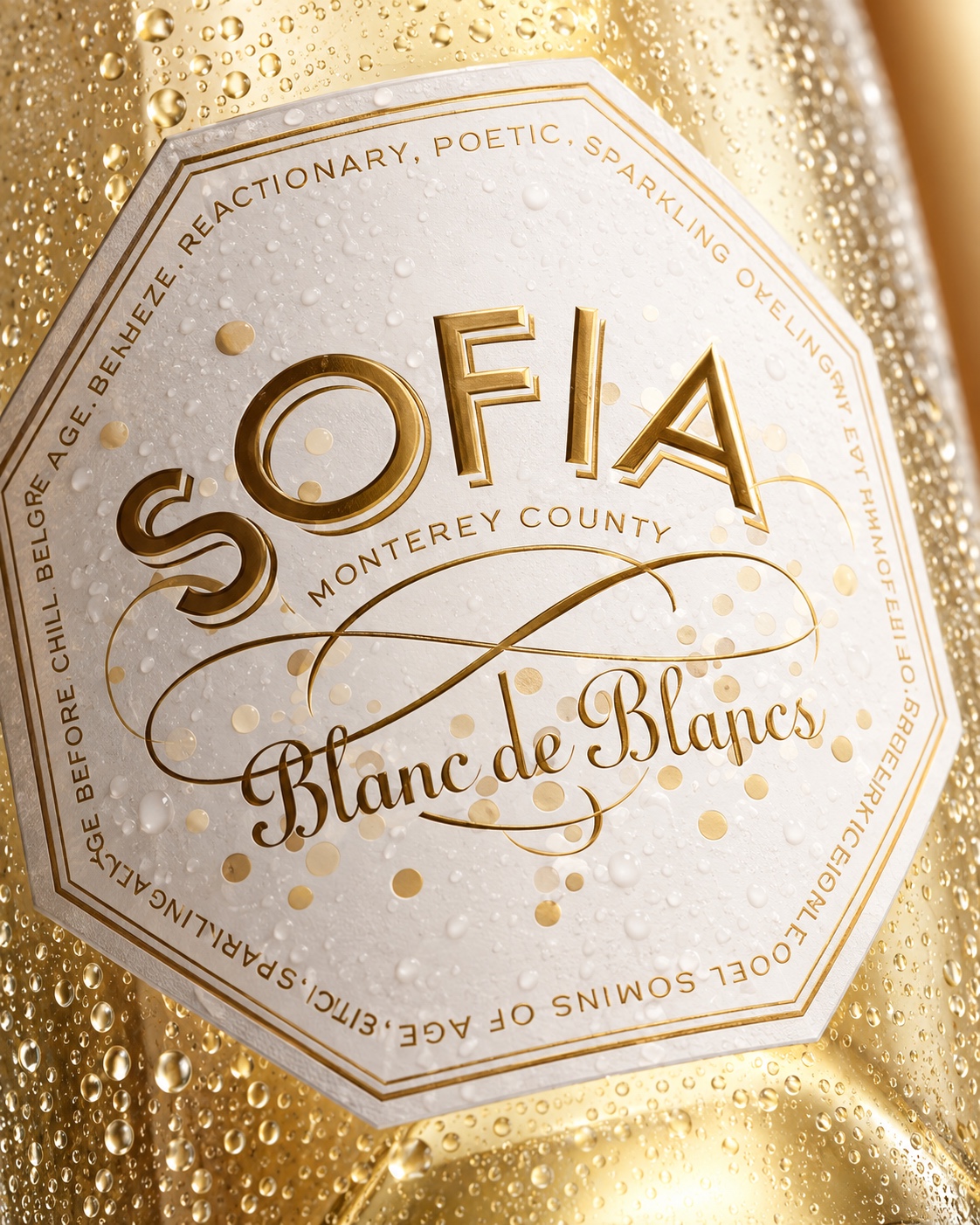Angled close-up of the gold Sofia Blanc de Blancs label with water droplets