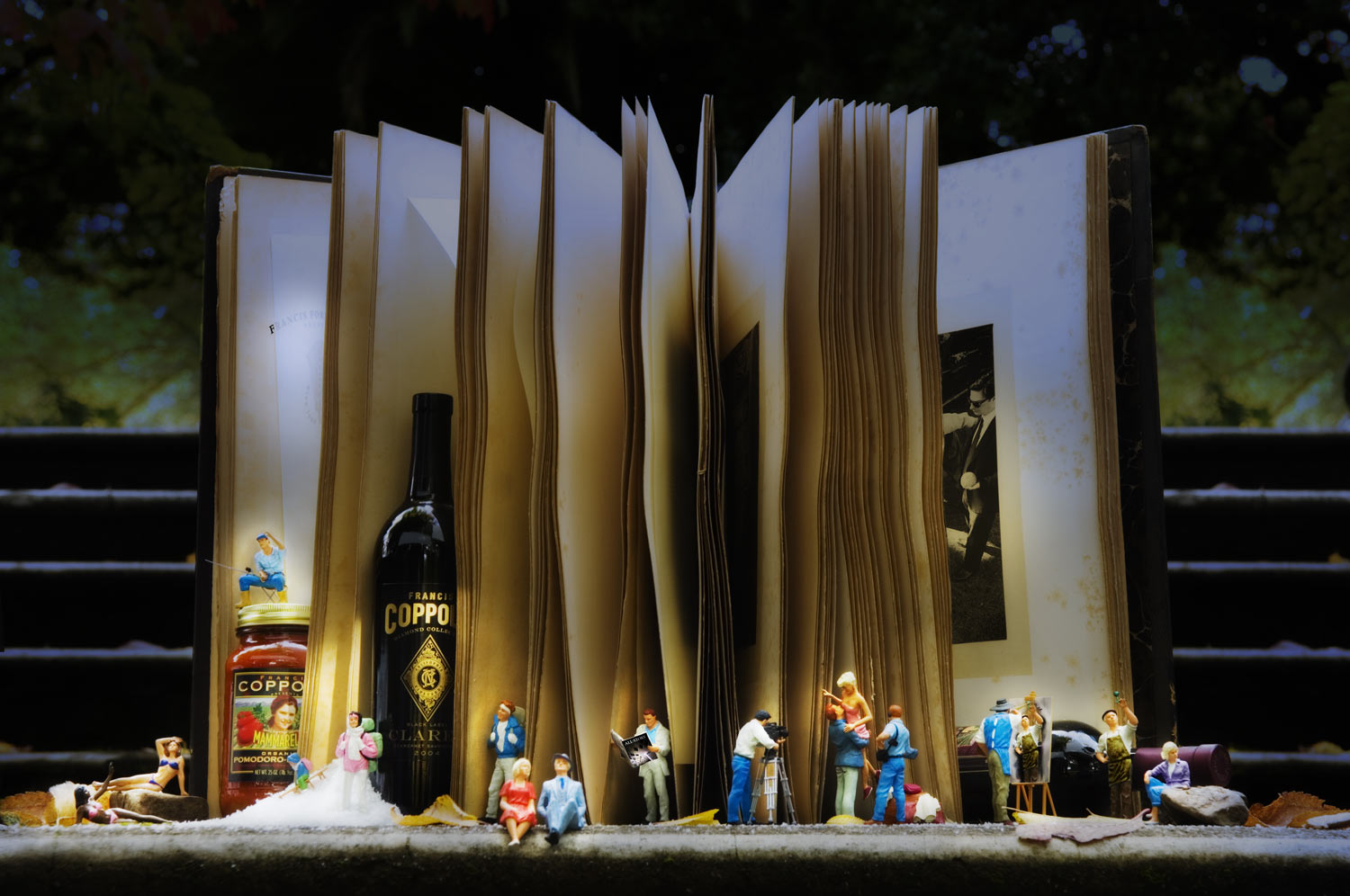 Coppola holiday still life with an open book, wine and miniature figures