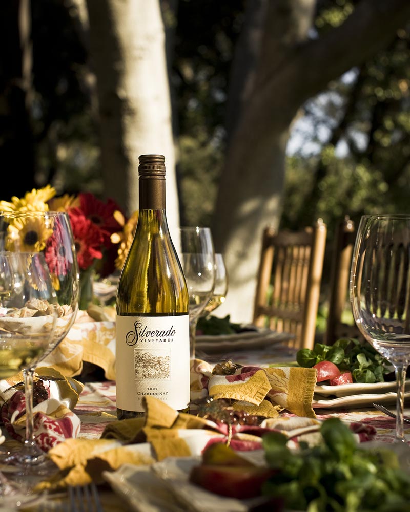 Silverado Chardonnay on a sunlit table with flowers and fresh food